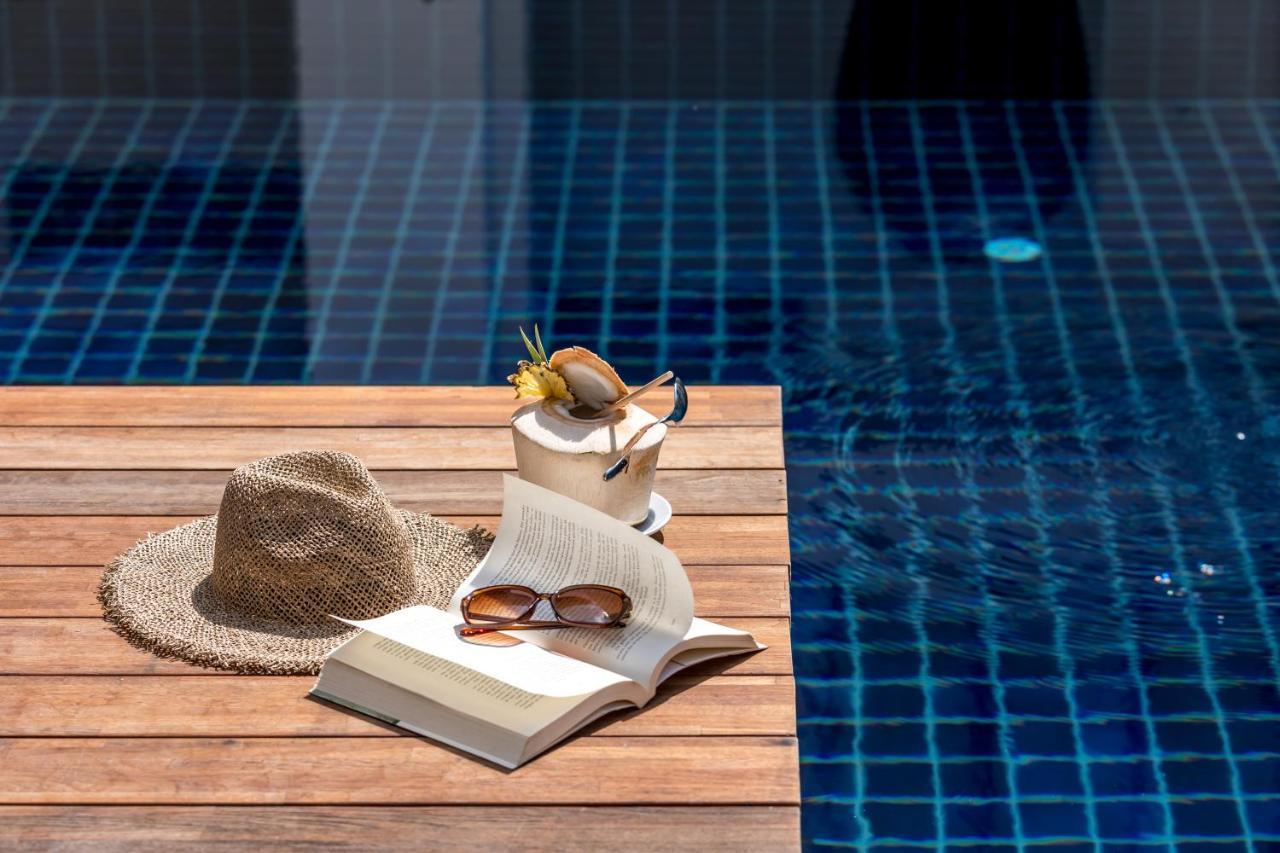 Outrigger Surin Beach Resort - Sha Extra Plus Bagian luar foto A poolside table