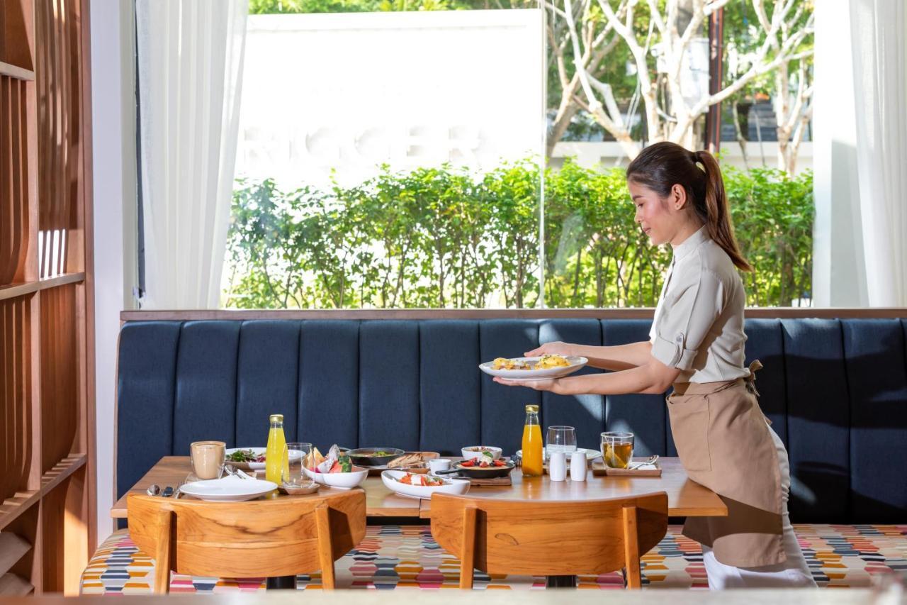 Outrigger Surin Beach Resort - Sha Extra Plus Bagian luar foto A Thai waitress serving food
